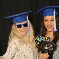 two friends in graduation caps taking a picture